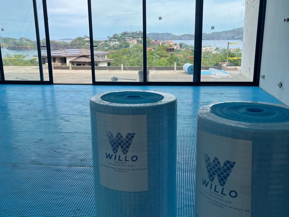 Willo Systems underlayment rolls staged on a job site floor with ocean view